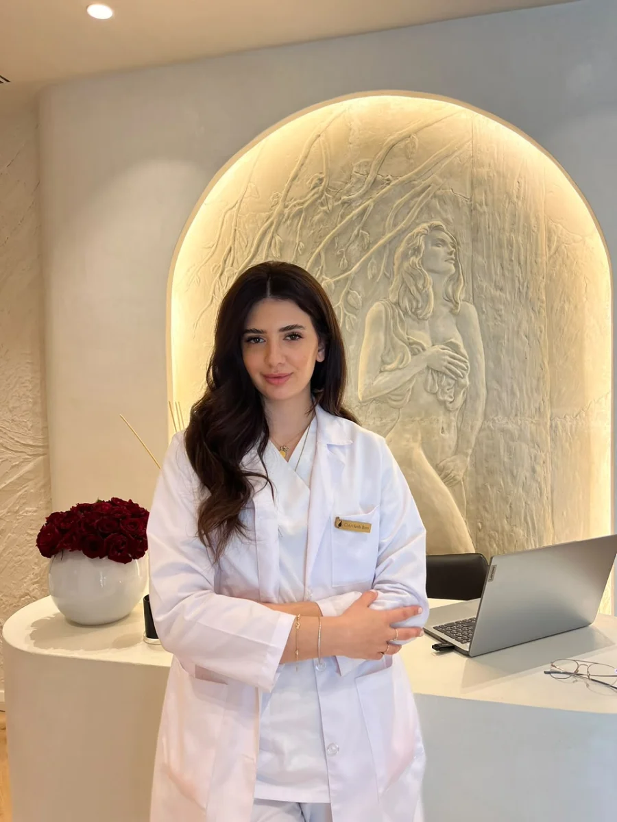 Keida Bojni at The Elixir Clinic reception, beneath the illuminated arch